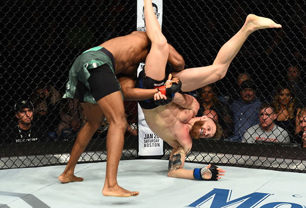 ST. LOUIS, MO - JANUARY 14: (L-R) Kamaru Usman of Nigeria takes down Emil Meek of Norway in their welterweight bout during the UFC Fight Night event inside the Scottrade Center on January 14, 2018 in St. Louis, Missouri. (Photo by Josh Hedges/Zuffa LLC)