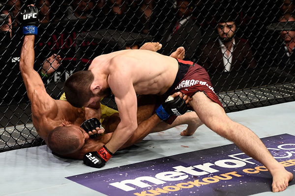LAS VEGAS, NV - DECEMBER 30: (R-L) Khabib Nurmagomedov of Russia punches Edson Barboza of Brazil in their lightweight bout during the UFC 219 event inside T-Mobile Arena on December 30, 2017 in Las Vegas, Nevada. (Photo by Jeff Bottari/Zuffa LLC)