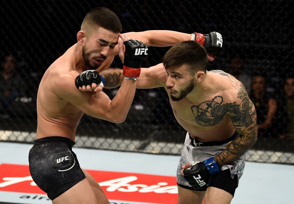 LAS VEGAS, NV - DECEMBER 30: (R-L) Matheus Nicolau of Brazil punches Louis Smolka in their flyweight bout during the UFC 219 event inside T-Mobile Arena on December 30, 2017 in Las Vegas, Nevada. (Photo by Jeff Bottari/Zuffa LLC)