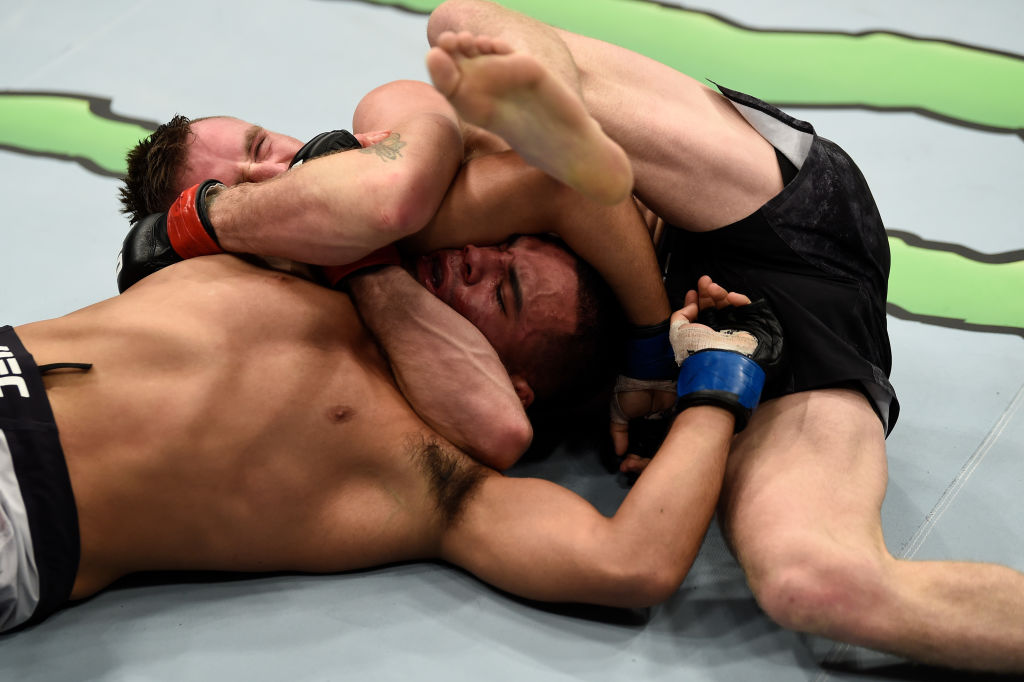 LAS VEGAS, NV - DECEMBER 30: (L-R) Tim Elliott secures an anaconda choke submission against Mark De La Rosa in their bantamweight bout during the UFC 219 event inside T-Mobile Arena on December 30, 2017 in Las Vegas, Nevada. (Photo by Jeff Bottari/Zuffa LLC)