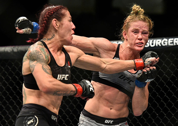 LAS VEGAS, NV - DECEMBER 30: (L-R) Cris Cyborg of Brazil punches Holly Holm in their women's featherweight bout during the UFC 219 event inside T-Mobile Arena on December 30, 2017 in Las Vegas, Nevada. (Photo by Brandon Magnus/Zuffa LLC)