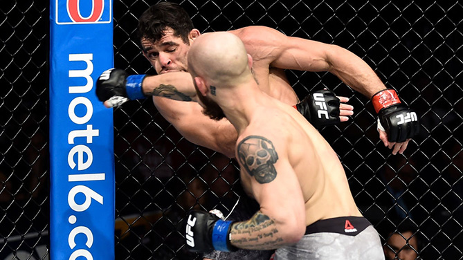 ORLANDO, FL - FEB. 24: (R-L) Brian Kelleher punches Renan Barao of Brazil in their bantamweight bout during the UFC Fight Night event at Amway Center. (Photo by Jeff Bottari/Zuffa LLC)