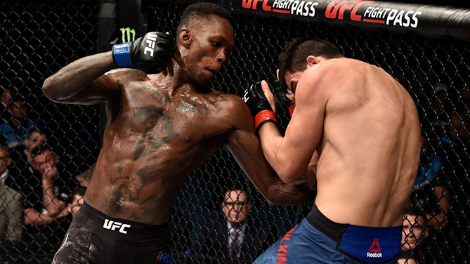 PERTH, AUSTRALIA - FEBRUARY 11: (L-R) Israel Adesanya of Nigeria punches Rob Wilkinson of Australia in their middleweight bout during the UFC 221 event at Perth Arena on February 11, 2018 in Perth, Australia. (Photo by Jeff Bottari/Zuffa LLC)