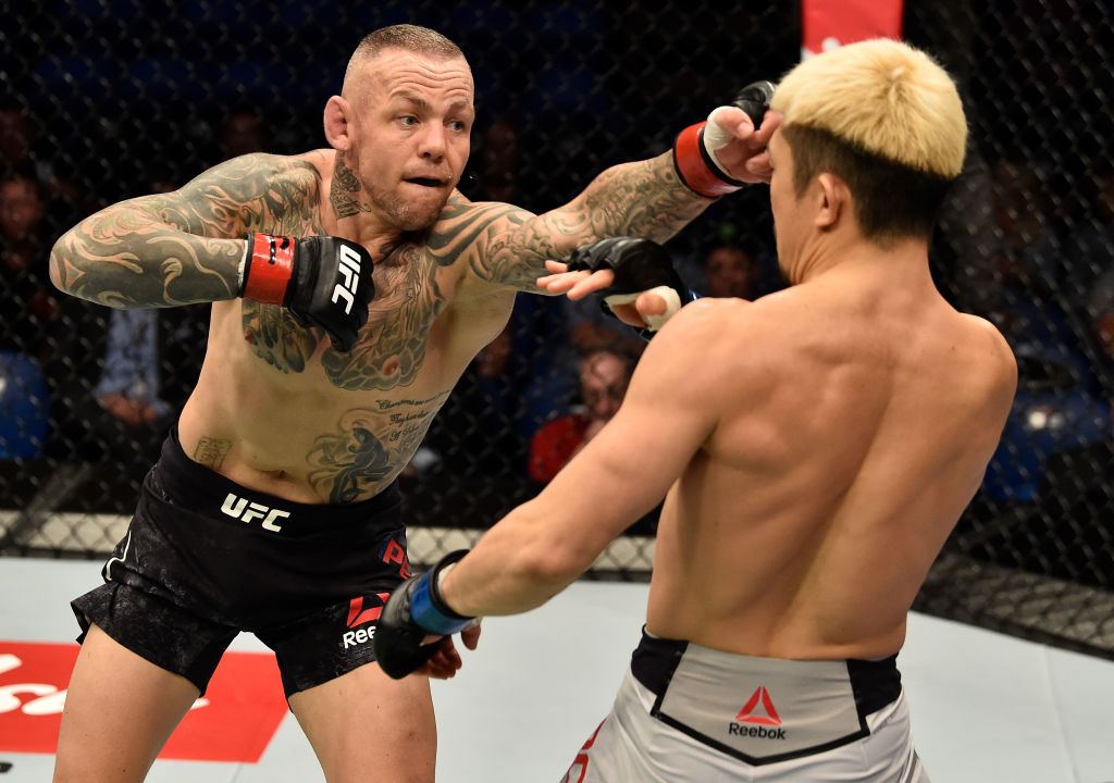 PERTH, AUSTRALIA - FEBRUARY 11: (L-R) Ross Pearson of England punchess Mizuto Hirota of Japan in their lightweight bout during the UFC 221 event at Perth Arena on February 11, 2018 in Perth, Australia. (Photo by Jeff Bottari/Zuffa LLC)