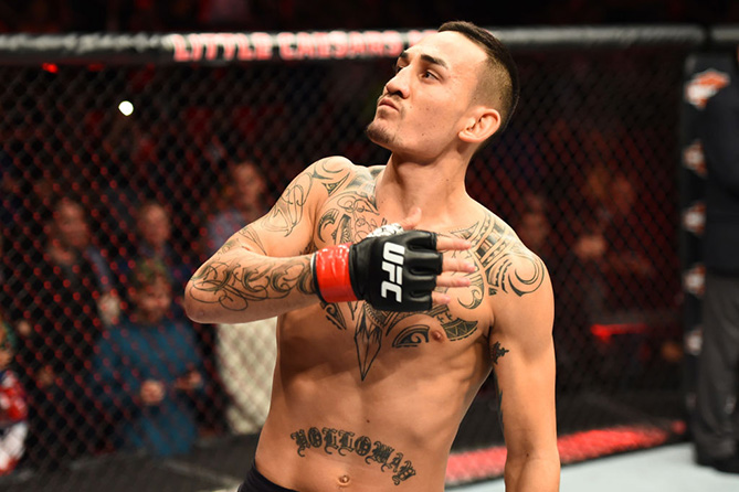 DETROIT, MI - DECEMBER 02: <a href='../fighter/Max-Holloway'>Max Holloway</a> signals to the crowd as he enters the Octagon prior to facing <a href='../fighter/Jose-Aldo'>Jose Aldo</a> of Brazil in their UFC featherweight championship bout during the UFC 218 event inside Little Caesars Arena on December 02, 2017 in Detroit, Michigan. (Photo by Josh Hedges/Zuffa LLC/Zuffa LLC via Getty Images)“ align=“center“/><br />Three months into 2018, Max Holloway still doesn’t have the words to describe his 2017 campaign in the Octagon, one that saw the laid back Hawaiian emerge as the undisputed featherweight champion by defeating Brazilian icon Jose Aldo in his hometown of Rio de Janeiro and solidify his standing atop the 145-pound ranks by duplicating that effort six months later at UFC 218 in Detroit.<p>Part of it is because last year was the culmination of a journey that started in the shadows more than four years ago with a second-round stoppage victory over <a href=