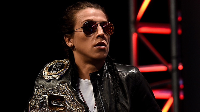 Joanna Jedrzejczyk poses with her belt at UFC 217 pre-fight press conference