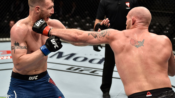 LAS VEGAS, NV - MARCH 03: (R-L) Jordan Johnson punches Adam Milstead in their light heavyweight bout during the UFC 222 event inside T-Mobile Arena on March 3, 2018 in Las Vegas, Nevada. (Photo by Jeff Bottari/Zuffa LLC)