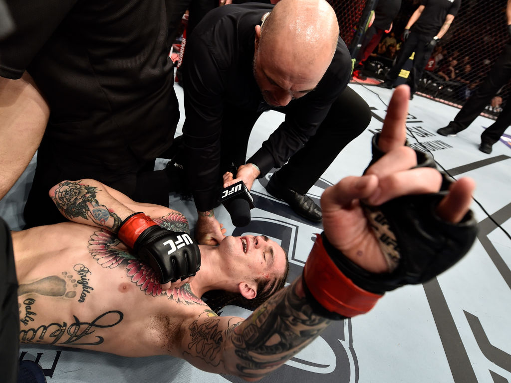 <a href='../fighter/Sean-O-Malley'>Sean O’Malley</a> is interviewed by Joe Rogan after his unanimous-decision victory over <a href='../fighter/Andre-Soukhamthath'>Andre Soukhamthath</a> at UFC 222 on March 3, 2018 in Las Vegas, NV. (Photo by Jeff Bottari/Zuffa LLC)“/>Ah, “The Sugar Show” keeps getting better. After taking his notoriety to a new level with his fight week appearance on UFC Embedded and during open workouts, he appeared to be on his way to a another highlight reel win against Andre Soukhamthath before a third-round leg injury made things even more interesting. Now, forced into a fight for survival, O’Malley showed his grit, made it out of the fight and to another win, which he capped off with a classic post-fight interview with Joe Rogan while lying on his back and getting his leg tended to. Simply put, the kid is a star.</p><p><strong>4 – <a href=