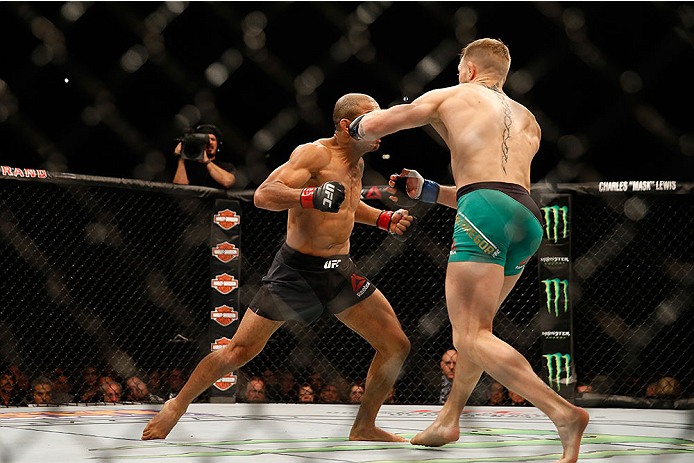 Conor McGregor punches Jose Aldo at UFC 194