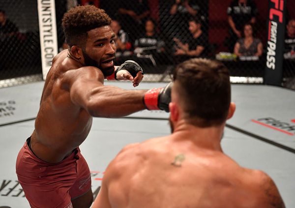 Chris Curtis punches Sean Lally in their welterweight bout during Dana White's Tuesday Night Contender Series at the TUF Gym on June 12, 2018 in Las Vegas, Nevada. (Photo by Jeff Bottari/DWTNCS LLC)