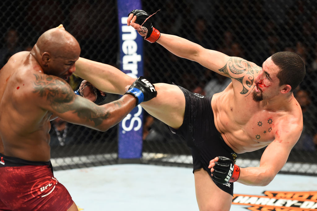 Robert Whittaker lands a kick to the head of <a href='../fighter/Yoel-Romero'>Yoel Romero</a> at UFC 225 (Photo by Josh Hedges/Zuffa LLC)“/>Fighting Yoel Romero with all your limbs is a tall order for anyone in the middleweight division. Robert Whittaker has done it twice – and won – with less than a full set, making those two victories even more impressive than they already are. Last summer, “The Reaper” injured his knee in the first round against “The Soldier of God” and still made a late surge to win a five-round decision. In Saturday’s rematch, it was Whittaker’s right hand that abandoned him, but again the New Zealand-born Aussie found a way to win in a 2018 Fight of the Year candidate. The victory, Whittaker’s ninth in a row, continues to build his reputation as a must see, regardless of weight class. My only concern with Whittaker’s future are the injuries that have stalled and handicapped him at times. But if he stays healthy, he’s got the talent and grit to stay on top for a long time.</p><p><strong>2 – <a href=