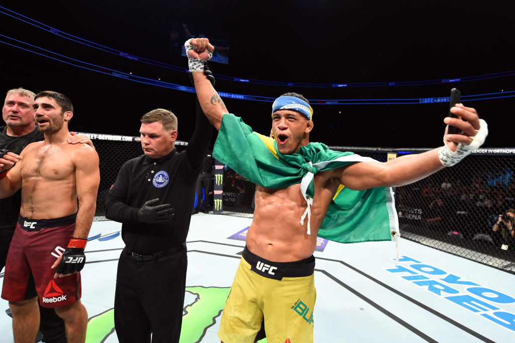 PITTSBURGH, PA - SEPTEMBER 16: (R-L) <a href='../fighter/Gilbert-Burns'>Gilbert Burns</a> of Brasil celebrates after knocking out <a href='../fighter/Jason-Saggo'>Jason Saggo</a> of Canada in their lightweight bout during the <a href='../event/UFC-Silva-vs-Irvin'>UFC Fight Night </a>event inside the PPG Paints Arena on September 16, 2017 in Pittsburgh, Pennsylvania. (Photo by Josh Hedges/Zuffa LLC/Zuffa LLC via Getty Images)“ align=“center“/><br />Fight game or not, you would be hard pressed to find a nicer guy than Gilbert Burns. Seriously. But when the classy Brazilian family man steps into the Octagon, let’s just say that nice guy disappears for 15 minutes or – often – less.<p>“I think I have to activate that mood,” he laughs. “I’m a 24-hour dad, a husband, a Christian, but as soon as I get in the Octagon, it’s a fight. It’s kill or be killed. I don’t want to be here that long and I don’t want the judges putting their hands in. I want to finish, I want to be the champion, and I’m hungry. As soon as I get in that cage, it clicks. I’m a fighter, I’m a competitor.”</p><p>That attitude has led him to a stellar 6-2 UFC record in which he’s finished five of those six victories, and it’s a good reason why his UFC 226 bout with <a href=