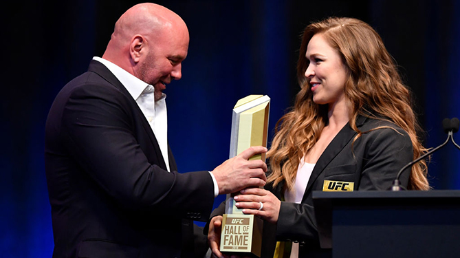 LAS VEGAS, NV - JULY 05: <a href='../fighter/Ronda-Rousey'>Ronda Rousey</a> receives her hall of fame trophy after being inducted into the UFC Hall of Fame during the UFC Hall of Fame Class of 2018 Induction Ceremony inside The Pearl concert theater at Palms Casino Resort on July 5, 2018 in Las Vegas, Nevada. (Photo by Jeff Bottari/Zuffa LLC via Getty Images)“ align=“center“/>The newest members of the UFC Hall of Fame were formally enshrined into UFC glory on Thursday night of the 7th annual International Fight Week.<p>Ronda Rousey, Art Davie, <a href=