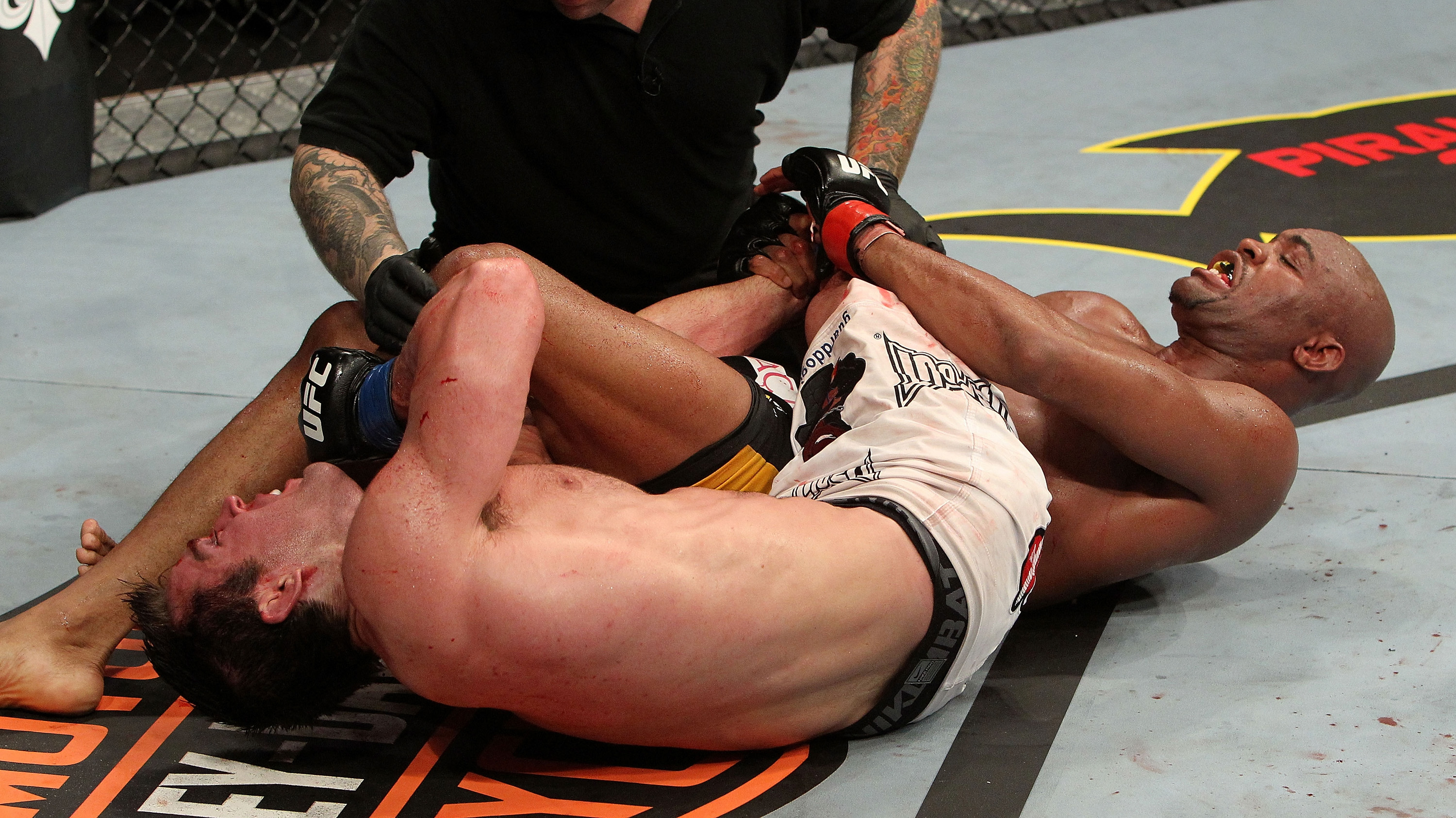 OAKLAND, CA - AUGUST 07: Referee Josh Rosenthal (C) stops the fight between <a href='../fighter/Chael-Sonnen'>Chael Sonnen</a> (L) and <a href='../fighter/Anderson-Silva'>Anderson Silva</a> (R) during the UFC Middleweight Championship bout at Oracle Arena on August 7, 2010 in Oakland, California. (Photo by Josh Hedges/Zuffa LLC via Getty Images)“ align=“center“/><strong>Anderson Silva vs. Chael Sonnen – <a href=