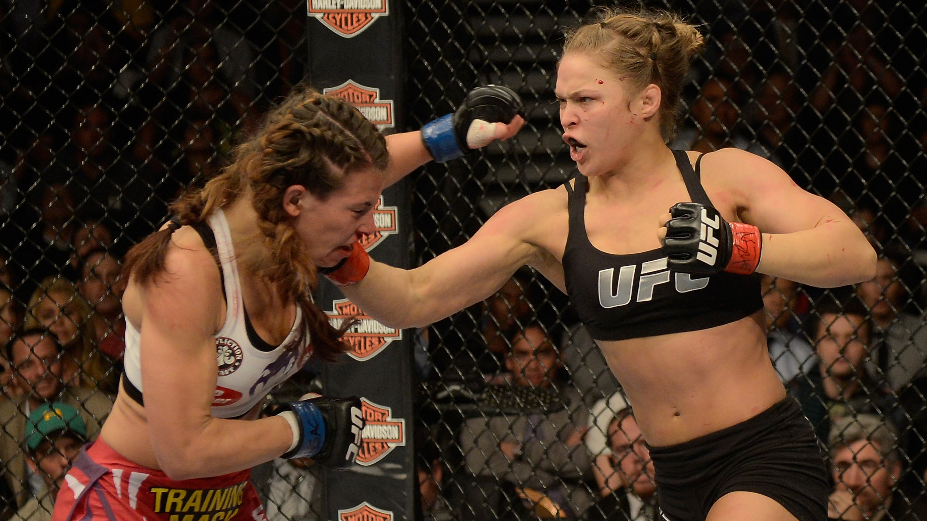 LAS VEGAS, NV - DECEMBER 28: (R-L) Ronda Rousey punches Miesha Tate in their UFC women's bantamweight championship bout during the UFC 168 event at the MGM Grand Garden Arena on December 28, 2013 in Las Vegas, Nevada. (Photo by Donald Miralle/Zuffa LLC via Getty Images)