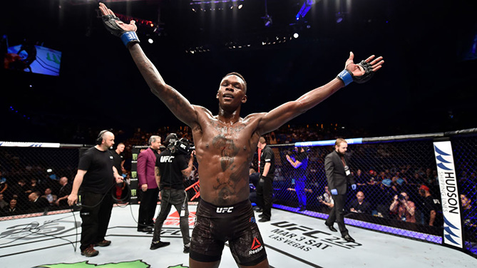 PERTH, AUSTRALIA - FEBRUARY 11: <a href='../fighter/Israel-Adesanya'>Israel Adesanya</a> of Nigeria celebrates his victory over <a href='../fighter/Rob-Wilkinson'>Rob Wilkinson</a> of Australia in their middleweight bout during the UFC 221 event at Perth Arena on February 11, 2018 in Perth, Australia. (Photo by Jeff Bottari/Zuffa LLC/Zuffa LLC via Getty Images)“ align=“center“/> The first time somebody watches Israel Adesanya fight, his rangy limbs and unpredictable striking style might remind a UFC fan of one of the best mixed martial artists ever: <a href=