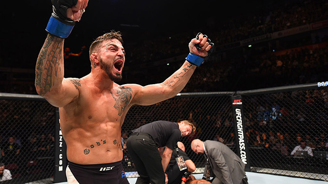 MANCHESTER, ENGLAND - OCTOBER 08: (L-R) <a href='../fighter/mike-perry'>Mike Perry</a> celebrates his knockout victory over <a href='../fighter/danny-roberts'>Danny Roberts</a> of England in their welterweight bout during the UFC 204 Fight Night at the Manchester Evening News Arena. (Photo by Josh Hedges/Zuffa LLC/Zuffa LLC via Getty Images)“ align=“center““/> With a penchant for finishing fights but never getting finished himself, Mike Perry’s entrance into the UFC coincided with him being an immediate fan favorite. The announcement that he’ll got to war with Donald ‘Cowboy’ Cerrone at Fight Night Denver sent understandable tremors of excitement throughout the MMA community, and quickly moved to the front of the line potential Fight of the Night.</div><p class=