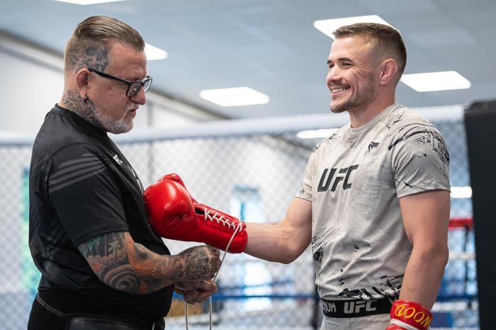 Nathaniel Wood has his boxing gloves tied with the help of his dad, Gary Wood inside Great Britain Top Team In Mitcham, South London, United Kingdom. (Photo by John Barry/Zuffa LLC)